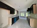Modern kitchen with dark cabinets, granite countertops, and stainless steel appliances at 226 Rolling Pasture Way, Sanford, NC 27332