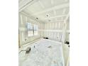 Unfinished room featuring a large window offering natural light, exposed framing and concrete flooring at 226 Rolling Pasture Way, Sanford, NC 27332