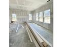 Unfinished room with multiple windows offering natural light, exposed framing and concrete flooring at 226 Rolling Pasture Way, Sanford, NC 27332