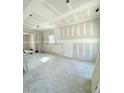 Spacious unfinished room featuring exposed framing, concrete flooring, and natural light from a window at 226 Rolling Pasture Way, Sanford, NC 27332
