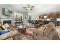 Cozy living room featuring a fireplace, plush seating, and seamless flow to the kitchen at 236 Star Valley Dr, Angier, NC 27501