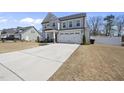 A lovely home featuring a two-car garage and a spacious concrete driveway at 239 Hopper Cir, Clayton, NC 27520