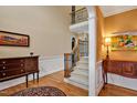 Elegant foyer with wood floors, staircase, and decorative table with artwork at 2550 Bittersweet Dr, Durham, NC 27705