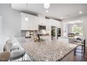 Modern kitchen with granite countertops, an island with seating, and stainless steel appliances at 262 Cardovia Way, Wendell, NC 27591