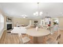 Open-concept living area featuring a fireplace, hardwood floors, and a breakfast bar at 275 Cardovia Way, Wendell, NC 27591