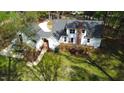 Expansive backyard featuring a solar panel array, deck, lush lawn and mature trees offering a private oasis at 2820 Mattlyn Ct, Raleigh, NC 27613