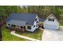Charming single-Gathering home featuring a cozy front porch and attached two-car garage nestled among lush trees at 2820 Mattlyn Ct, Raleigh, NC 27613