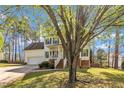 Beautiful home showcasing a well-maintained lawn, attached garage, and a charming front porch entrance at 3 Guilder Cv, Durham, NC 27713