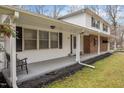 Inviting front porch, with ample seating space and classic brick accents at 315 Dumont Dr, Hillsborough, NC 27278