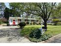 Lovely single-story home boasts a well-kept lawn, mature trees, and inviting curb appeal at 3516 Apache Dr, Raleigh, NC 27609