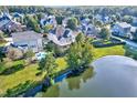 Stunning aerial view of the property, featuring a private pool and scenic lake frontage at 404 Vintage Hill Cir, Apex, NC 27539