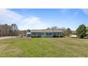 Inviting single-story home with a quaint front porch and a spacious front yard at 41 Rock Bluff Ln, Kittrell, NC 27544