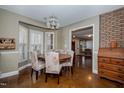Formal dining room with wood table and upholstered chairs overlooking another living space at 4105 Lassiter Rd, Wake Forest, NC 27587