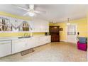 Bright kitchen featuring white cabinetry, vintage flooring, and ample counter space at 413 S Maple St, Graham, NC 27253