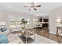Bright, open floor plan with hardwood floors, living room, dining area, and modern kitchen at 50 Yelverton Ct, Holly Springs, NC 27540