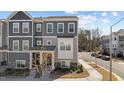 Charming townhome with stone accents, gray siding, and well-maintained landscaping at 5200 Invention Way, Raleigh, NC 27616