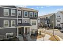 Inviting gray townhome with a stone foundation and an inviting entryway at 5200 Invention Way, Raleigh, NC 27616