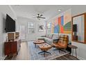 Bright living room with stylish decor, comfortable seating, and modern ceiling fan at 5200 Invention Way, Raleigh, NC 27616