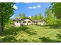 Ranch-style home showcasing its manicured lawn and mature trees in a serene, suburban setting at 5313 Edington Ln, Raleigh, NC 27604