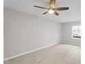 Well-lit bedroom with a ceiling fan and window showcasing the neighborhood views at 5340 Big Bass Dr, Raleigh, NC 27610