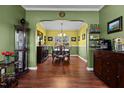 Spacious dining room with hardwood floors, chandelier lighting and decorative shelving at 5405 Seaspray Ln, Raleigh, NC 27610