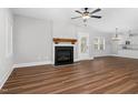Living room featuring a fireplace, ceiling fan, and hardwood floors at 5450 Hunter Hill Rd, Rocky Mount, NC 27804