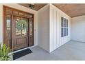 Close-up of an elegant wooden front door with glass panels and a decorative wreath at 5725 Lord Granville Way, Rolesville, NC 27571