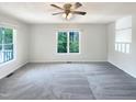 Bright and airy bedroom featuring neutral carpet and paint, a ceiling fan, and ample natural light at 610 Shepard School Rd, Zebulon, NC 27597