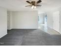 Spacious living room featuring neutral paint, ceiling fan, carpet and ample room for furniture at 610 Shepard School Rd, Zebulon, NC 27597