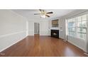 Bright living room with fireplace, ceiling fan, and hardwood floors at 63 Halter Ct, Angier, NC 27501