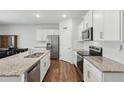 Bright kitchen with granite countertops, stainless steel appliances, and ample cabinet space at 909 Sea Holly Dr, Zebulon, NC 27597
