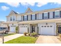 Charming townhome featuring a one car garage, covered entrance, and neatly manicured landscaping at 946 Consortium Dr, Raleigh, NC 27603