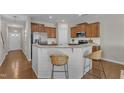 Modern kitchen boasts stainless steel appliances, breakfast bar, granite countertops, and ample cabinet space at 946 Consortium Dr, Raleigh, NC 27603