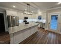 Modern kitchen featuring stainless steel appliances, granite countertops, and a center island at Lot 14H Good Shepherd Trl, Spring Hope, NC 27882