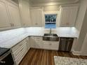This kitchen showcases granite countertops, a stainless steel sink, and subway tile backsplash at Lot 14H Good Shepherd Trl, Spring Hope, NC 27882