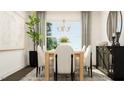 Elegant dining room with a stylish light fixture, large window, and modern furniture at 1004 Red Roses Ave, Durham, NC 27703