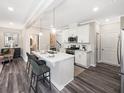 Modern kitchen features white cabinets, quartz countertops, stainless steel appliances, and pendant lighting at 1005 Red Roses Ave, Durham, NC 27703