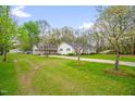 Attractive single-story home with an attached carport on an expansive lawn with mature trees at 1022 Glover Rd, Dunn, NC 28334