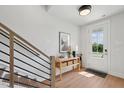 Inviting entryway featuring hardwood floors, a modern staircase, and a console table with decor at 1034 Zelkova Ln, Chapel Hill, NC 27517