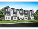 Modern townhomes in a row with attractive landscaping and sidewalks in a newly developed neighborhood at 1034 Zelkova Ln, Chapel Hill, NC 27517