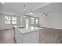 Open concept kitchen with island and stainless steel sink, adjacent to living area at 104 Fairwinds Dr, Lillington, NC 27546