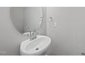 Modern half bathroom featuring a pedestal sink, neutral paint, and an oval mirror above the sink at 104 Ripple Way # 318, Clayton, NC 27520