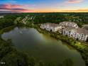 Scenic aerial of residential multi-Gathering homes near a tranquil lake with a fountain and wooded surroundings at 10400 Rosegate Ct # 3, Raleigh, NC 27617