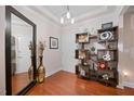 Charming foyer with hardwood floors, decorative shelving and statement mirror at 10400 Rosegate Ct # 3, Raleigh, NC 27617