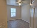 Bright bedroom with a ceiling fan, a window for natural light and durable flooring at 11711 Mezzanine Dr # 109, Raleigh, NC 27614