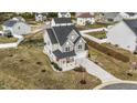 Aerial view of a gray two-story home with an expansive yard and a swing set in a Gathering-friendly neighborhood at 118 Lockhaven Dr, Garner, NC 27529
