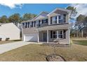 Charming two-story home with gray brick facade, a well-manicured lawn, and attached two-car garage at 1253 Manor Dr, Rocky Mount, NC 27804