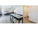 Open-concept living area featuring modern bar, a sleek sofa, and wood-look flooring at 1253 Manor Dr, Rocky Mount, NC 27804
