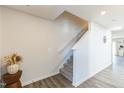 A carpeted staircase with white walls and trim, complemented by modern decor and wood-look flooring at 1253 Manor Dr, Rocky Mount, NC 27804