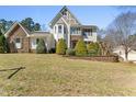 Charming two-story home featuring stone accents, a beautifully landscaped yard, and vibrant shrubbery at 12812 Baybriar Dr, Raleigh, NC 27613